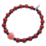 Dana Levy pink jade heart gemstone bracelet with large red carnelian gemstone beads and black striped glass beads on a white background. 