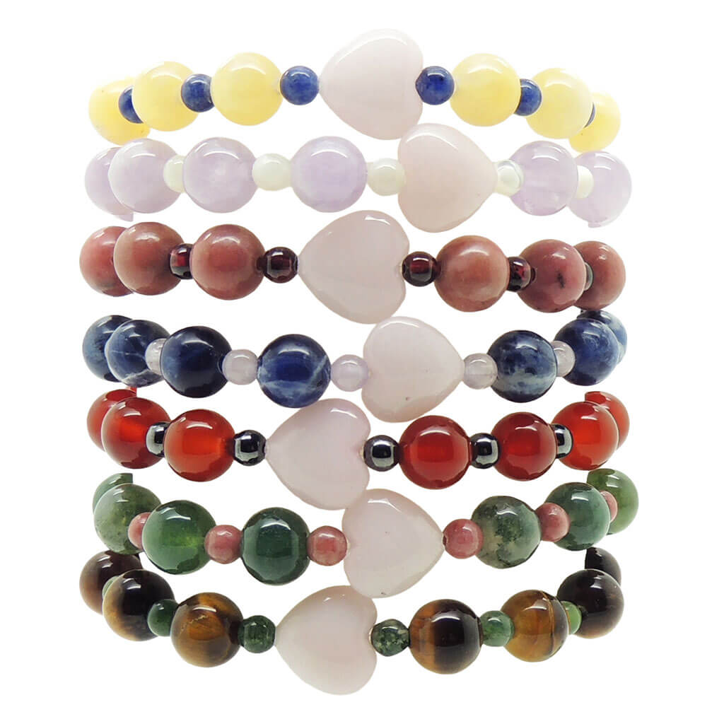 Dana Levy stack of colourful heart charm gemstone beaded bracelets on a white background.