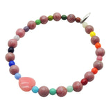 Dana Levy pink heart charm rhodonite gemstone bracelet with rainbow glass beads on white background. 