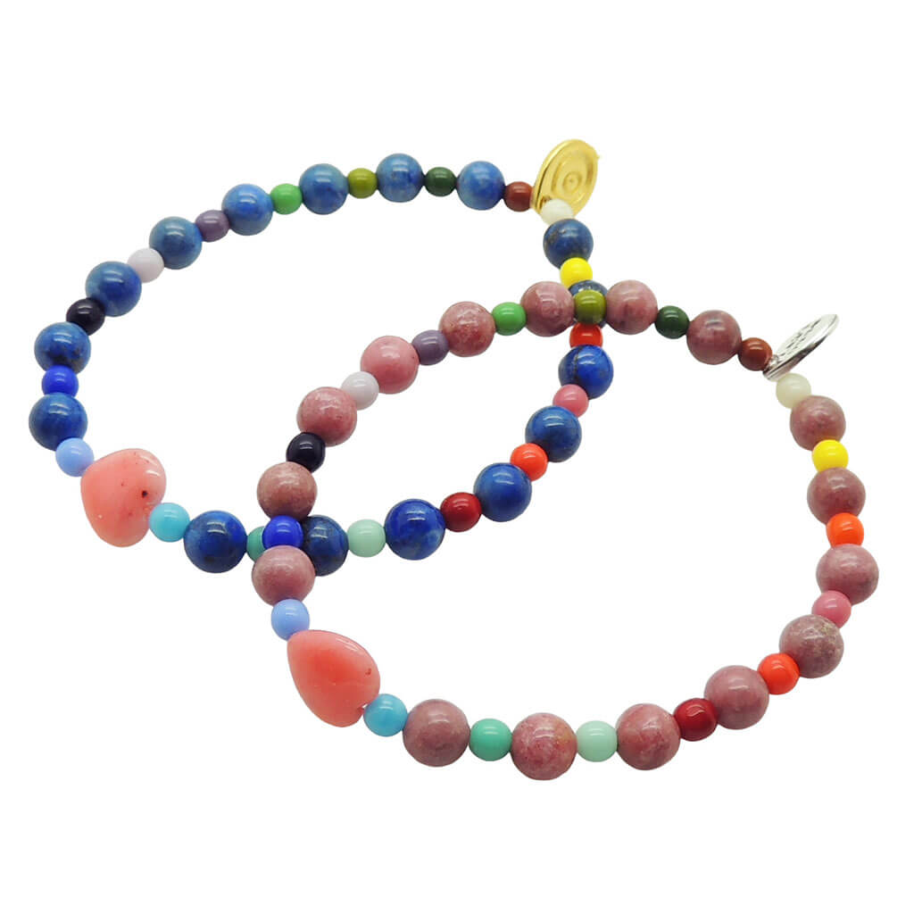 Dana Levy pair of pink heart charm rhodonite gemstone bracelets in lapis lazuli and rhodonite with rainbow glass beads on a white background. 