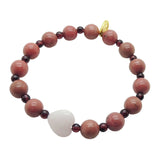 Dana Levy jade heart  charm gemstone bracelet with pink rhodonite and red garnet beads on a white background. 