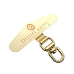 Dana Levy metal gold phone charm strap card with 'dana levy' branding on a white background.