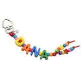 A Dana Levy maxi alphabet personalised name bag charm with DANA in large acrylic letters in rainbow colours and charm beads on a white background. 