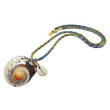 Dana Levy large spiral seashell charm with a small cowrie shell charm on a blue green and brown braid cord necklace side view on a white background. 