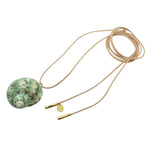 Dana Levy maxi spiral seashell charm leather lariat cord necklace with an turquoise/brown/Ivory shell, natural cord and gold plated cord ends, on a white background. 