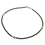 Black glass bead necklace with silver skull charms on a white background. design by Dana Levy 
