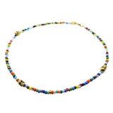 a gold plated skull charm trio multicolour glass bead mix necklace on a white background by Dana Levy  