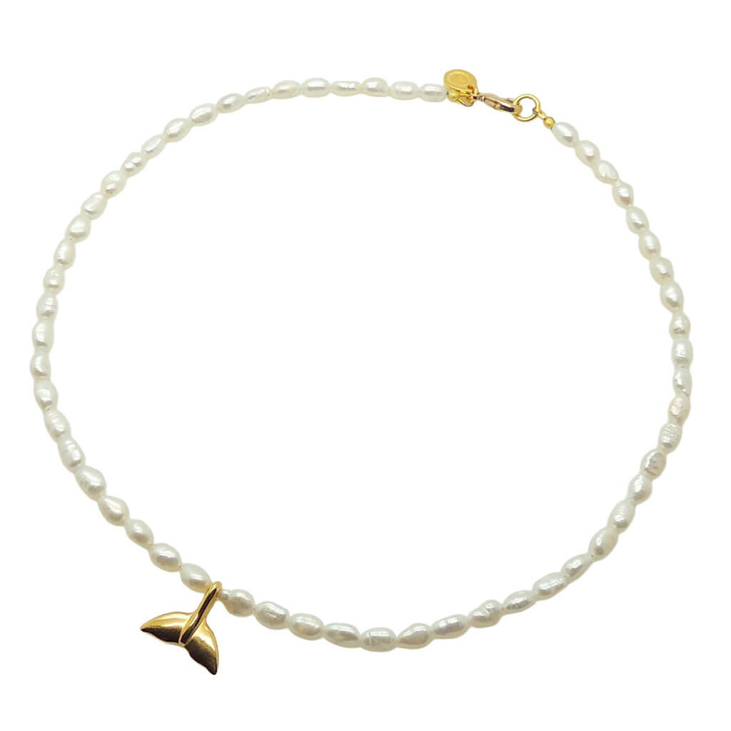 Dana Levy gold plated mermaid tail charm freshwater pearl necklace on a white background. 