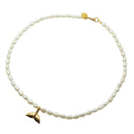 Dana Levy gold plated mermaid tail charm freshwater pearl necklace on a white background. 