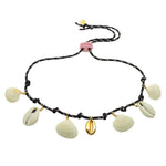 Dana Levy black cord necklace with gold plated and shell pendants on a white background