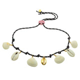 Dana Levy black cord necklace with gold plated and shell pendants on a white background