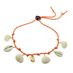 Dana Levy orange cord necklace with gold plated and seashell pendants on a white background.