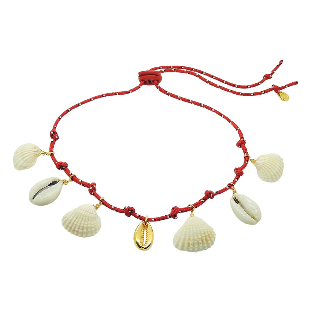 Dana Levy necklace with red cord gold and white shell pendants on a white background