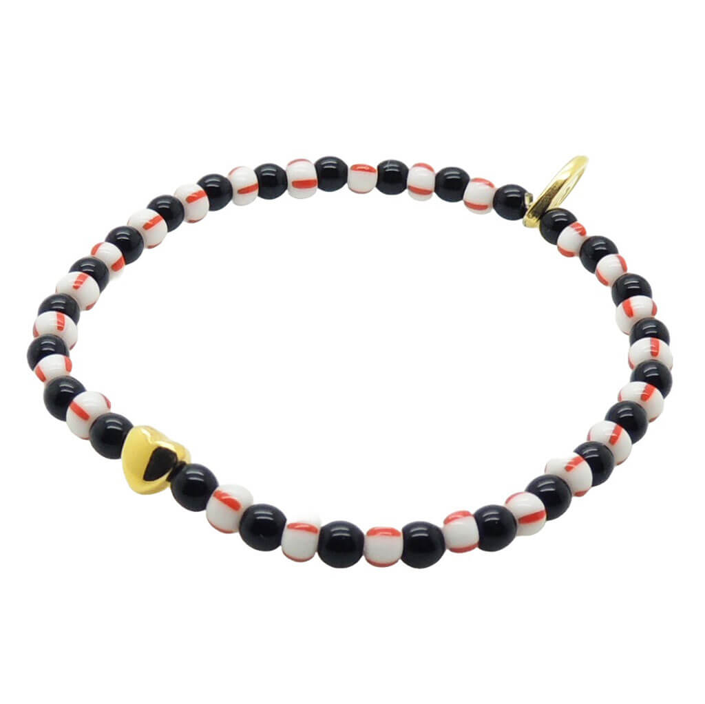 Dana Levy bracelet with a gold plated heart charm, and black, white, and red striped glass beads on a white background.
