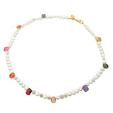 A Dana Levy freshwater pearl necklace with multicolour Ombre Rhinestone Crystals spaced along necklace, with a gold plated necklace, on a white background.
