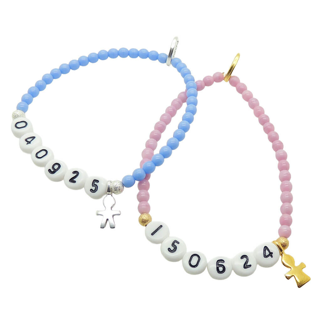 a pair of Dana Levy blue and pink glass bead bracelets with milestone dates in acrylic letters and mini boy and girl icon charms, on a white background. 