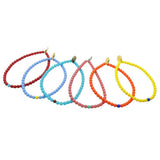 Set of brightly coloured Dana Levy glass beaded bracelets on a white background