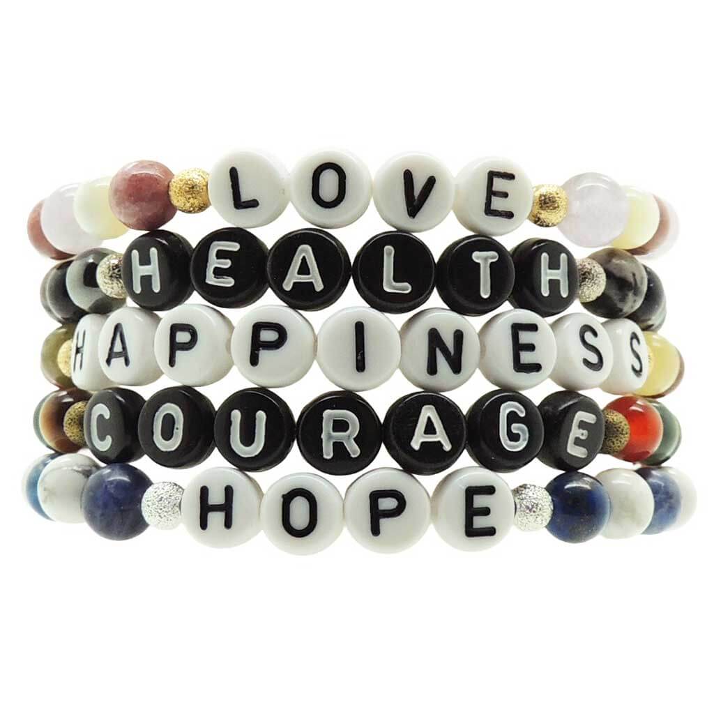 Dana Levy Stack of beaded semi precious gemstone bracelets with personalised motivational words on a white background
