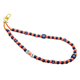 Dana Levy peach and navy beaded phone strap with blue evil eye cube charms and DL initial cubes on a white background. 