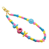 Dana Levy colourful acrylic beaded phone charm strap with alphabet letters reading joy and a blue smiley flower charm with a gold clasp on a white background.