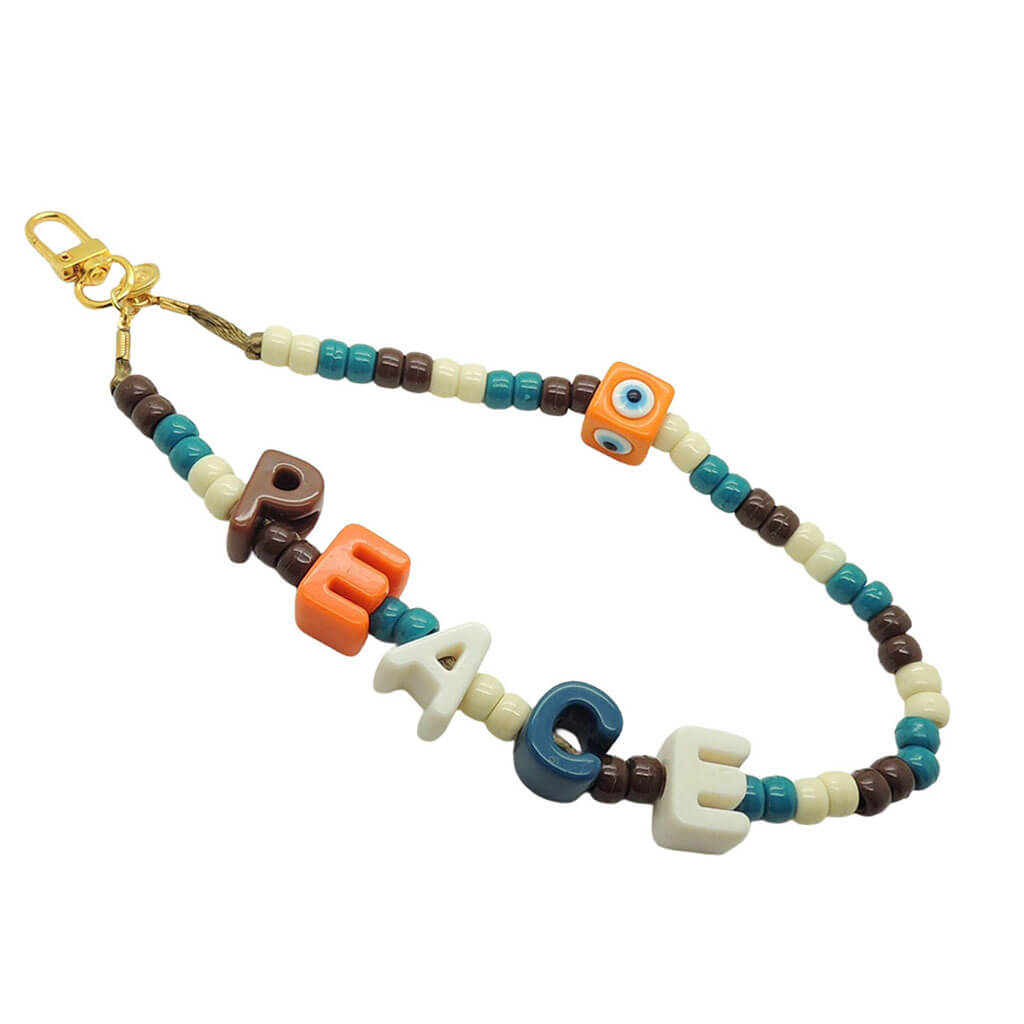Dana Levy colourful acrylic beaded phone charm strap with peace in chunky alphabet letters  and an orange evil eye cube charm with a gold clasp on a white background