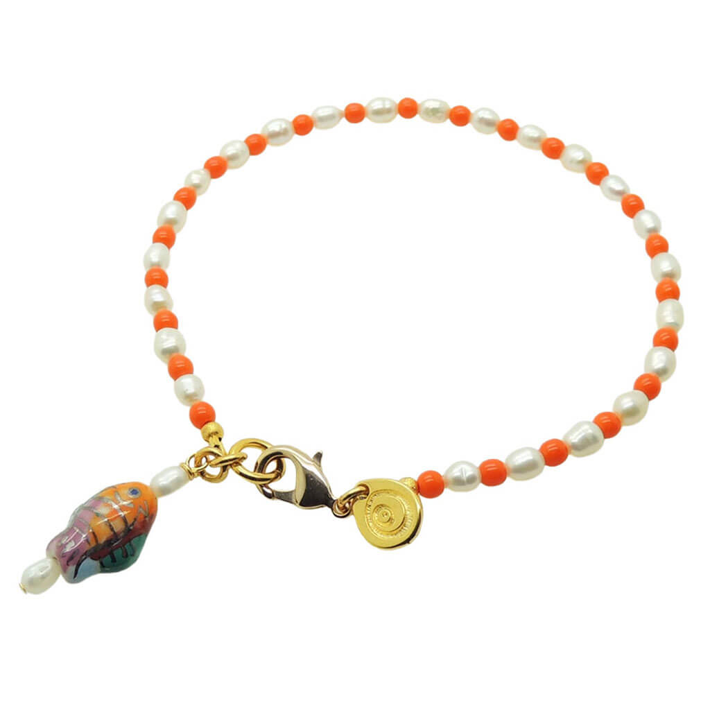 Dana Levy porcelain fish charm freshwater pearl glass bead mix anklet with orange glass beads and gold plated clasp on a white background. 