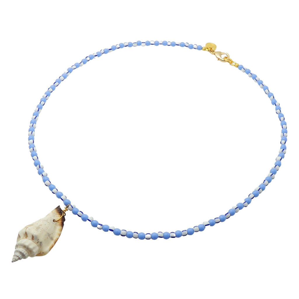 Dana Levy beaded necklace with cornflower blue and white and navy striped beads and a conch shell pendant on a white background.