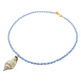 Dana Levy beaded necklace with cornflower blue and white and navy striped beads and a conch shell pendant on a white background.