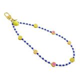 Dana Levy Sicilian tutti frutti charm two tone glass bead phone wristlet strap with fruit mix, royal blue and white glass bead mix on a white background.