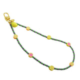 Dana Levy Sicilian tutti frutti charm glass bead phone wristlet strap with fruit mix, dark lilac and green glass bead mix on a white background.