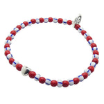 Dana Levy heart charm bracelet with red, white, and blue striped glass beads on a white background.