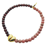 Dana Levy gemstone bracelet with garnet and rhodonite beads and a gold split heart charm on a white background.