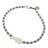 Dana Levy white bone fish charm striped glass bead mix anklet with dark lilac glass beads and white/green striped glass beads and an antique silver plated clasp on a white background. 
