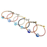 Six Dana Levy men's braided leather bracelets with glass evil eye amulet charms in various colours, arranged diagonally on a plain white background.