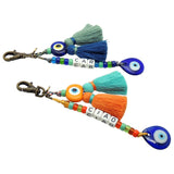 Dana Levy Personalised Alphabet Cube Evil Eye Charm Tassel Keyring - A Duo of Antique Gold Plated Key Fobs with Car and Ciao Spelled Out with Alphabet Letter Cubes and Decorated with Evil Eye Amulets and Double Tassel Charms.