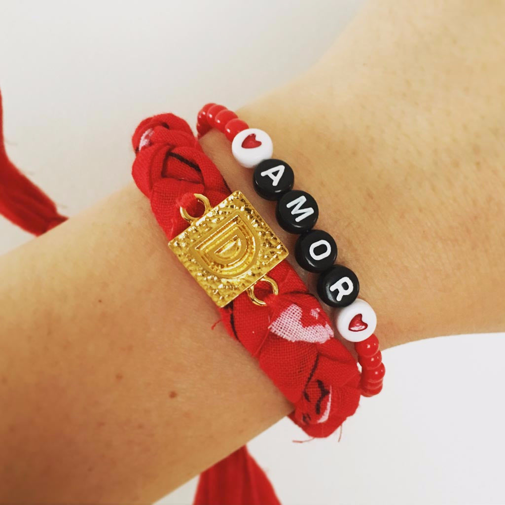 Dana Levy Red Alphabet Charm Bandana Braid Bracelet on Wrist with Amor Bracelet