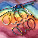 Dana Levy Personalised Name Alphabet Charm Cord Bracelet - Happy Holiday Flatlay 