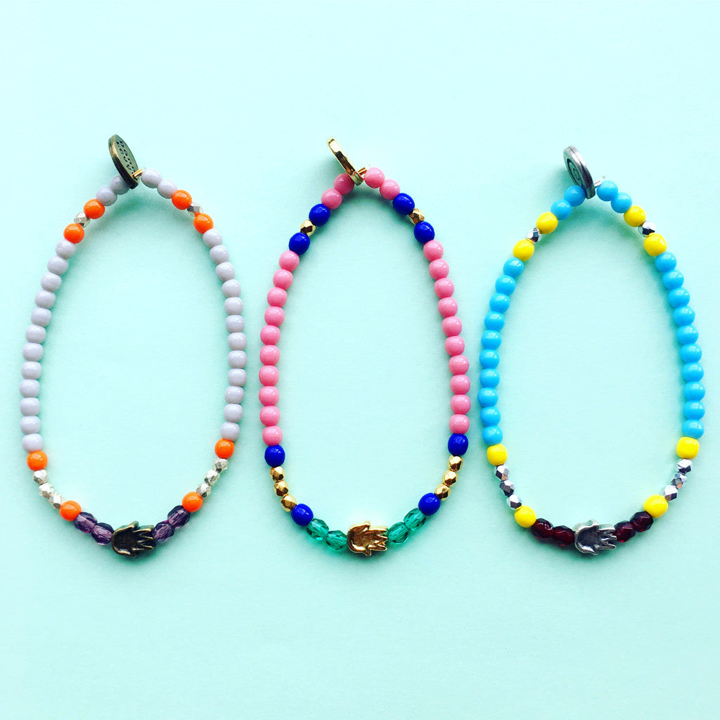 Dana Levy Solid Mini Hamsa Hand Charm Glass Bead Mix Bracelet - Trio on mint flatlay