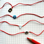 Dana Levy Evil Eye Red String Bracelet - On Notebook Instagram