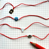 Dana Levy Evil Eye Red String Bracelet - On Notebook Instagram