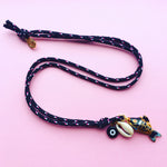Dana Levy Limited Edition Cloisonné Fish Charm Trio Cord Necklace - Black on Pink Background