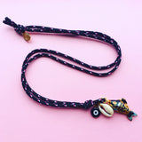 Dana Levy Limited Edition Cloisonné Fish Charm Trio Cord Necklace - Black on Pink Background