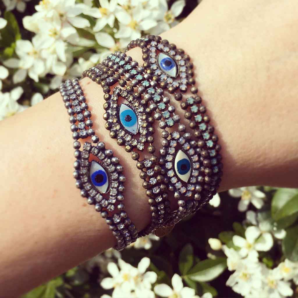 Dana Levy Mother of Pearl Evil Eye Charm Swarovski Crystal Ball Chain Bracelet - All Crystal Combinations on Wrist Floral Background