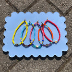 Dana Levy Solid Mini Hamsa Hand Charm Glass Bead Mix Bracelet - Group on Blue Flatlay 