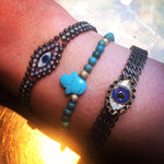 Dana Levy Mother of Pearl Evil Eye Charm Swarovski Crystal Ball Chain Bracelet - on Wrist with Hamsa Gemstone Bracelet and Evil Eye Cuff