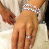Dana Levy personalised name custom glass bead bracelets spelling out Bride 2 Be and Kululu on a wrist for a wedding hen party. 
